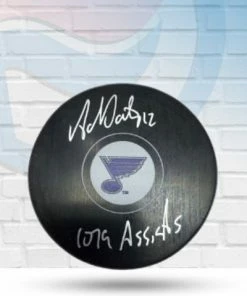 Fan Cave Sports Autographed Memorabilia Adam Oates St Louis Blues Autographed Logo Puck W/ "1079 Assists" Inscription - COA